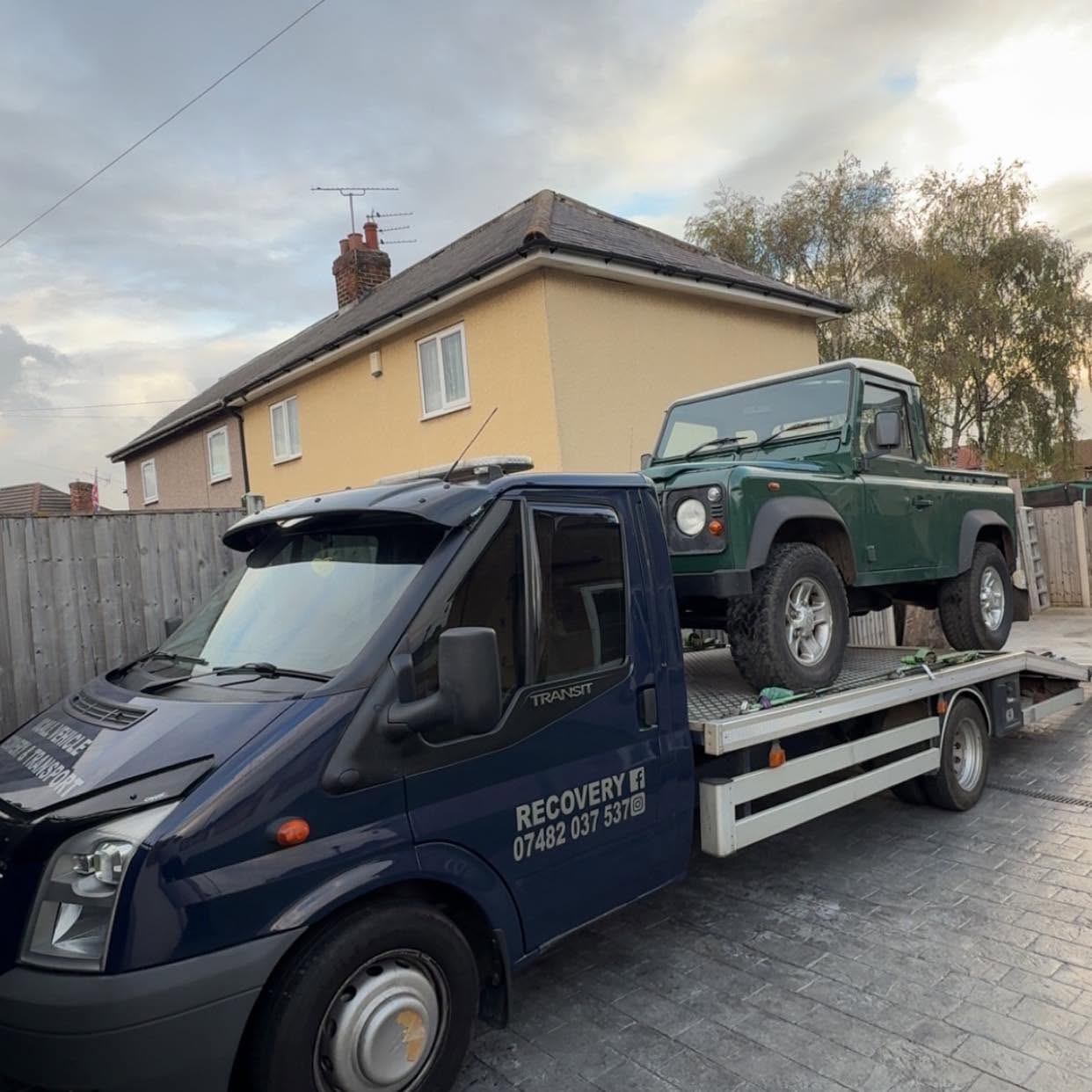 An Ocall recovery truck carrying a vehicle